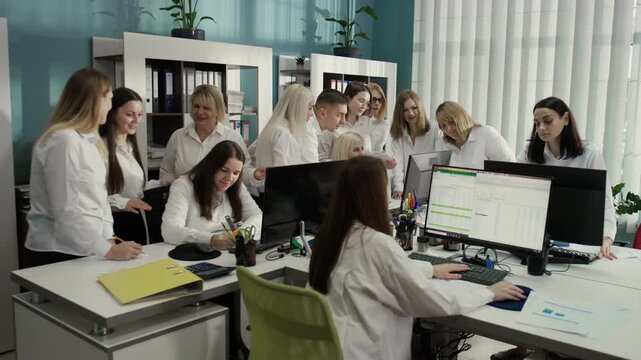 Cinematic footage of a brainstorming session in a young team of accountants in a modern office. Everyone is focused on their monitors and looking for solutions. 4K.
