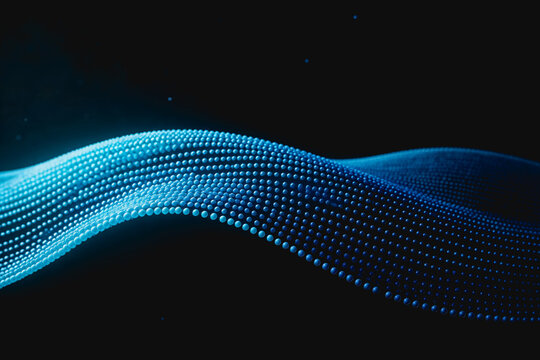 A dynamic glowing blue particle wave curves against a dark background, representing digital data flow and futuristic technology.