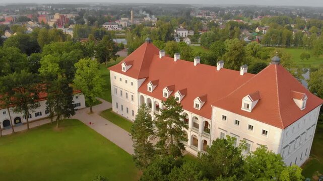 An aerial shot captures the beautifully reconstructed Biržai Castle, a 16th century earth bastion type fortress and palace complex located in the city of Biržai, Lithuania.