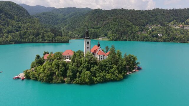 Island church on Lake Bled in Slovenia surrounded by trees and clear blue water
