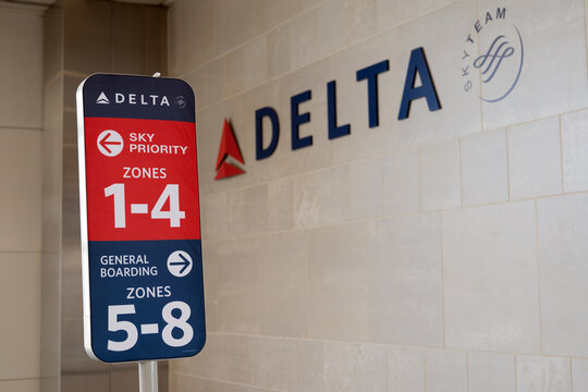 Detroit, Michigan, USA - 31 May 2026 : Delta airlines boarding sign at Detroit DTW airport terminal gate against the official Delta logo, mounted on tiled wall.