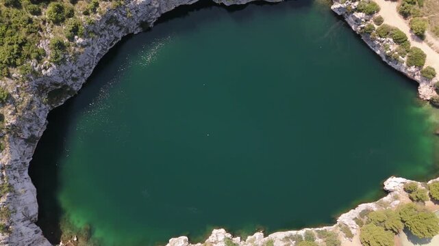 Dragon Eye Lake aerial top down hovering view with shining waters Zmajevo oko Rogoznica Croatia