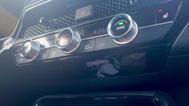 Modern car dashboard control panel with climate dials