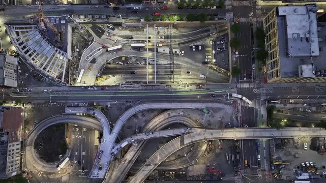 Aerial view of Lincoln Tunnel Expressway showing complex highway ramps and urban infrastructure at night in New York, New York, United States.