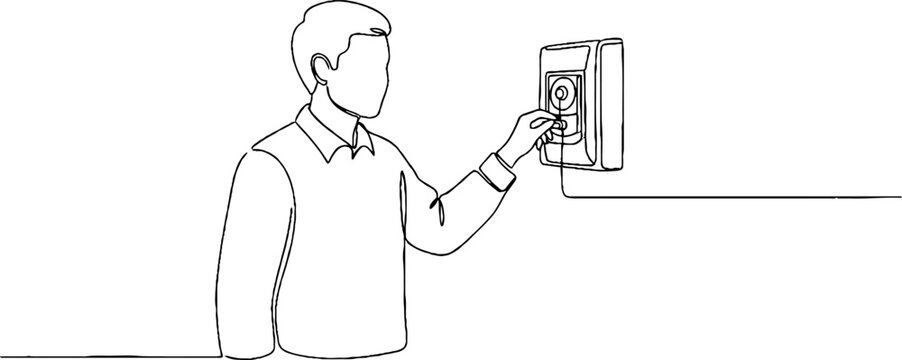 Man using digital security keypad on wall.