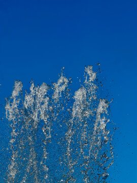 Water fountain splashing under a blue sky in Korea.