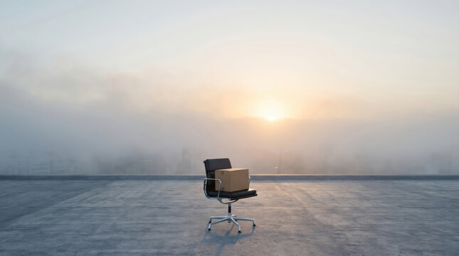Empty Office Chair with Cardboard Box, Layoff and Career Transition Concept
