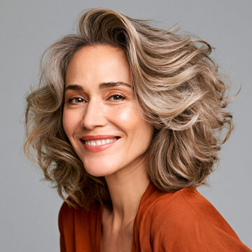 radiant woman aged 45 to 55 with healthy shiny hair, natural beauty and wellness concept
