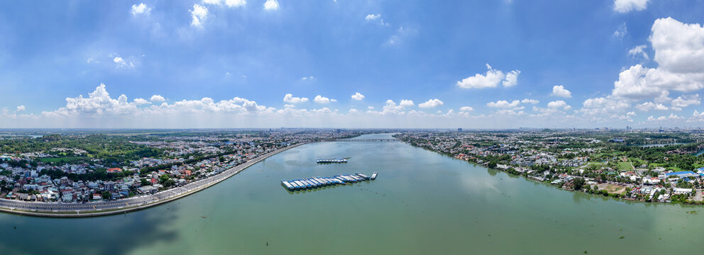 Aerial drone panorama of a riverside city under a blue sky