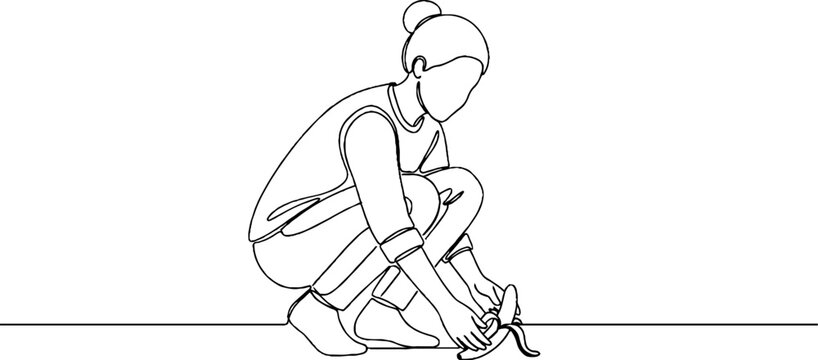 Person tying shoelaces in crouching position.