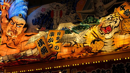 Vibrant Japanese Lantern Festival Parade with Tiger, Crane, and Sumo Wrestler Decorations © HariBudi