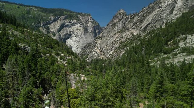 Aerial view of Yosemite Valley showcasing dramatic granite cliffs, lush forests, and winding river under natural daylight in California&rsquo;s Sierra Nevada.