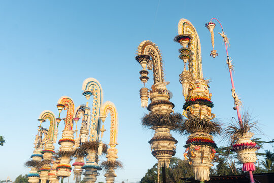 Environmental Wide Shot of Galungan Penjor Groups in Warm Evening Light with Large Open Sky Bali