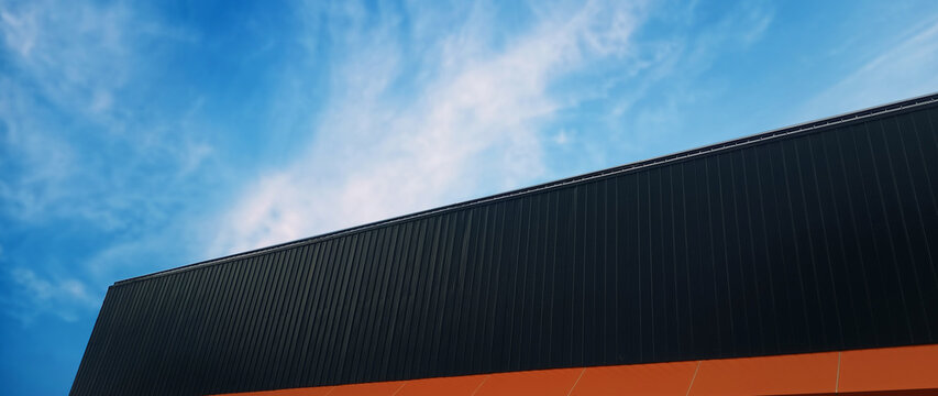 Metal sheet roof curve on blue sky. Modern construction, Metal ribbed arch span roof covering, Large building roof. not ai