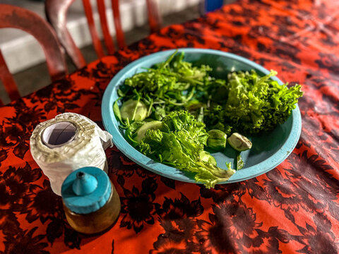 fresh vegetables, raw vegetables such as lettuce, cucumber, and small round eggplants at the catfish pecel stall.