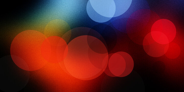 Abstract dark background with vibrant red blue orange bokeh circles creating festive and colorful light effect.