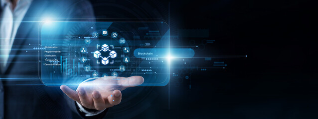 Crypto developer operates a handheld pad to view a virtual screen managing secure Blockchain ledgers. Decentralized crypto transactions and smart contract networks are checked regularly today. © NexPix