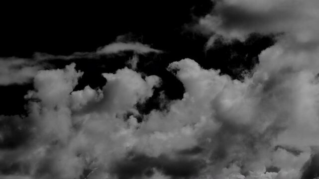 Time-lapse of separate white clouds on a black background has real clouds. Time-lapse of white fluffy cumulus cloud isolated