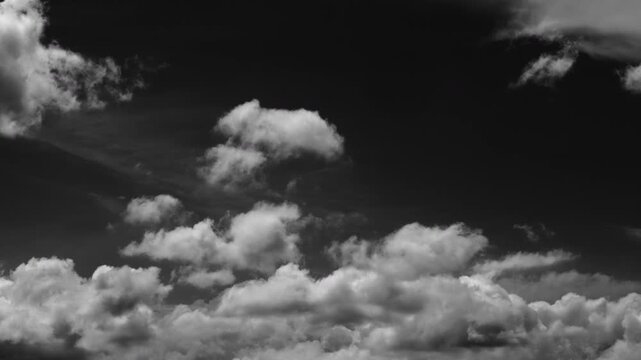 Dynamic cloud motion captured with a high-contrast black background.