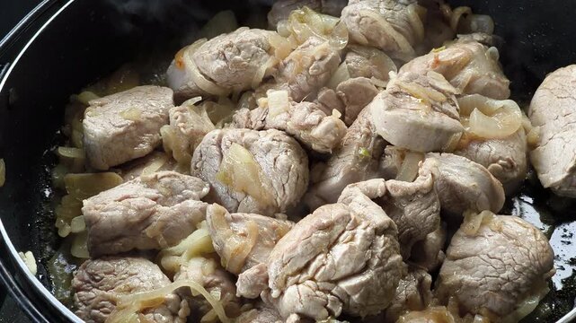 Homemade pork dish slowly cooked with chopped onions until soft and flavorful.