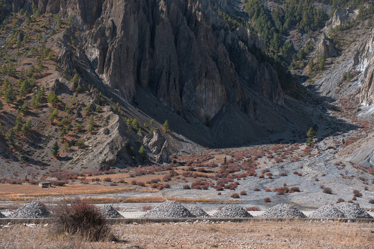 Dramatic Rocky Mountain Formations Above Dry Riverbed in Manang Nepal