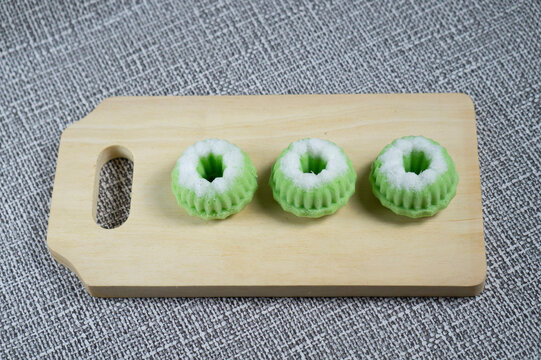 Traditional Indonesian Putu Ayu Cakes on Wooden Cutting Board