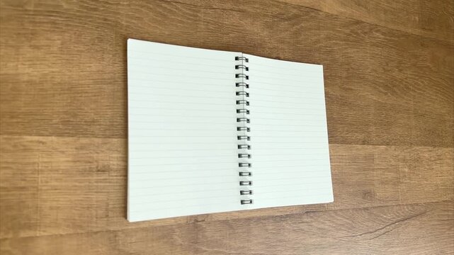 Hand Picking Up Yellow Pen from Open Notebook and Fading Out, 4K