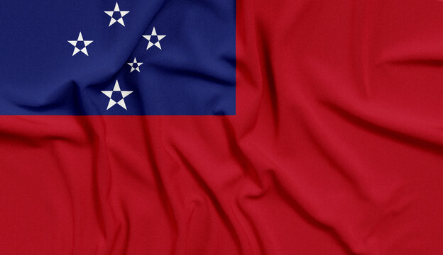 Samoa flag features five white stars on a blue canton against a red fabric background that creates a textured surface.