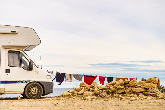 Washing laundry hanging to dry outdoors at caravan. Camping on nature, lifestyle.