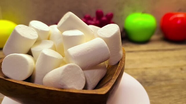 marshmallows on a wooden plate on the table