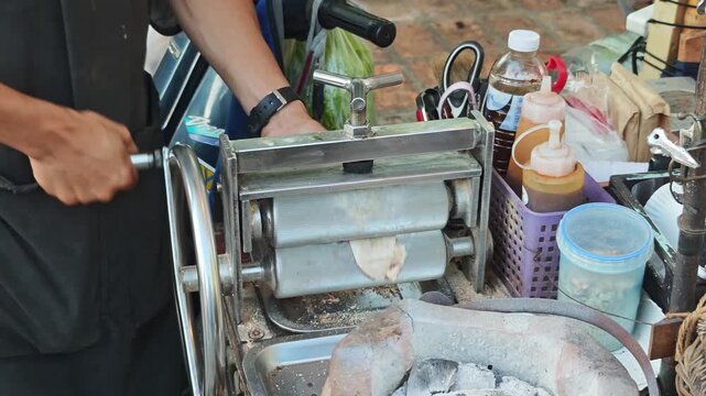 Dried squid grilled over a fire in the market.
