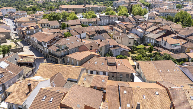 Allariz, Spain - 13 June 2026: Aerial view of the historic town featuring terracotta rooftops, narrow streets, and stone buildings under a bright summer sky.