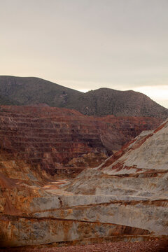 Vast open pit mine carved into a mountain landscape