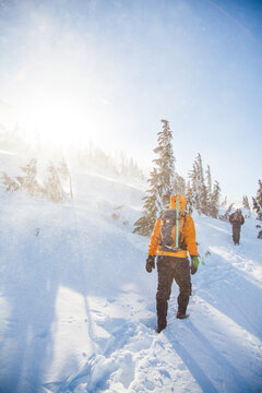 Hikers walking up a windy snowy mountain