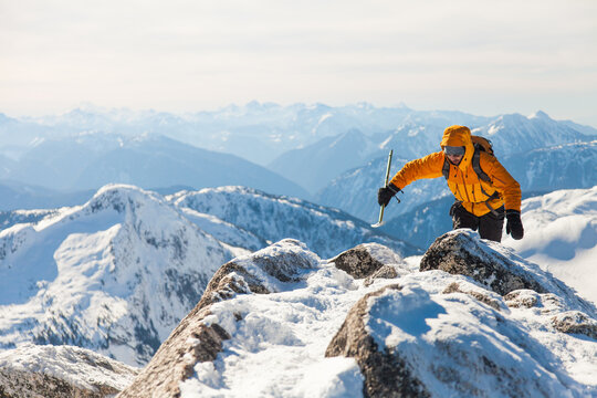 Mountaineer ascending a snowy mountain peak