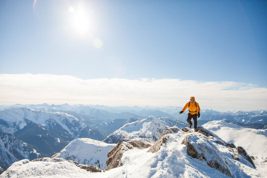 Mountain climber treks across a snowy peak