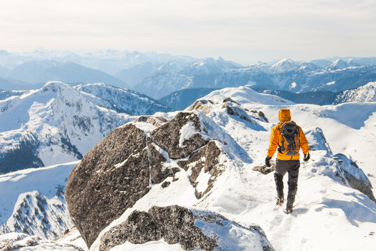 Rear view of Mountaineer on mountain summit