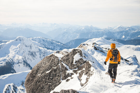 Hiker explores a vast snowy mountain range