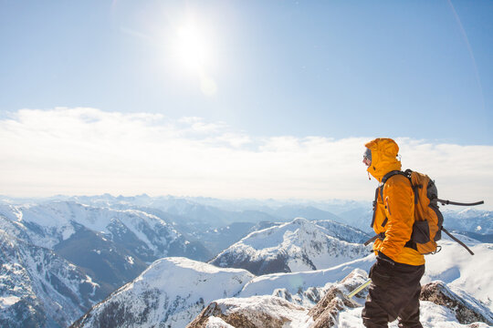 Side view of climber on mountain summit with view