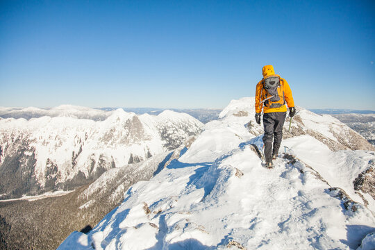 Mountaineer trekking on a snowy mountain ridge