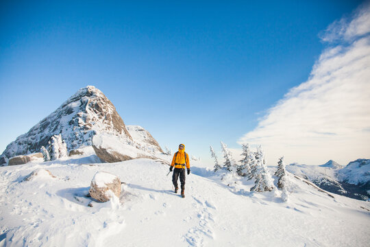 Mountaineer descends from summit in winter conditions