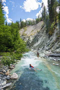 Man floating down a turquoise glacial river