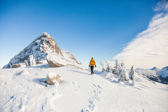 Adventurous hiker explores a snowy mountain landscape