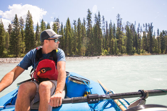 Man enjoys a summer day rafting down a river