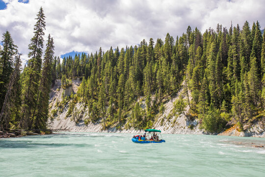 Tourists on a scenic float trip down a turquoise river