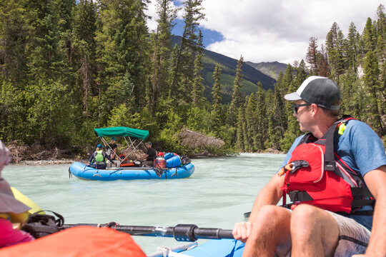 Over the shoulder view of a river rafting expedition