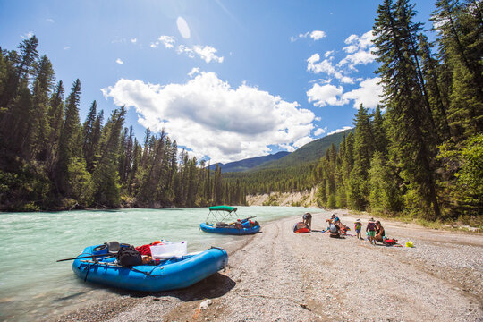 Family relaxing on a sunny river rafting break