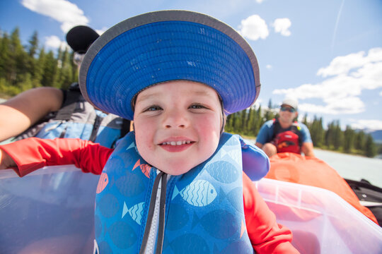 Smiling toddler boy enjoying a sunny boat ride