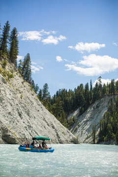 Group enjoying a raft trip on a scenic mountain river