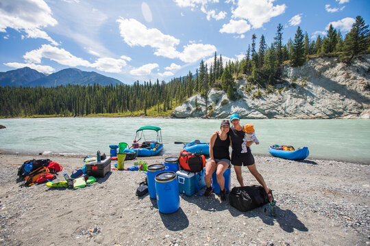 Family smiles for a photo on a river rafting expedition